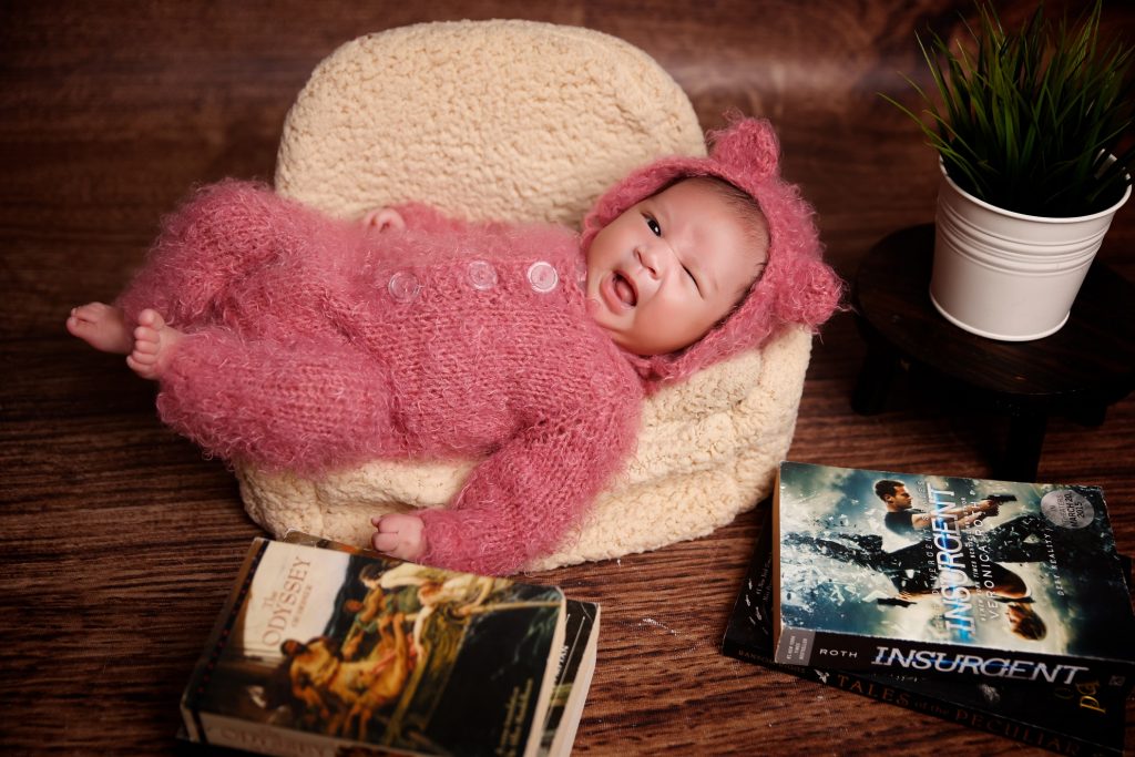 Baby Felisse winking at the camera for her newborn session