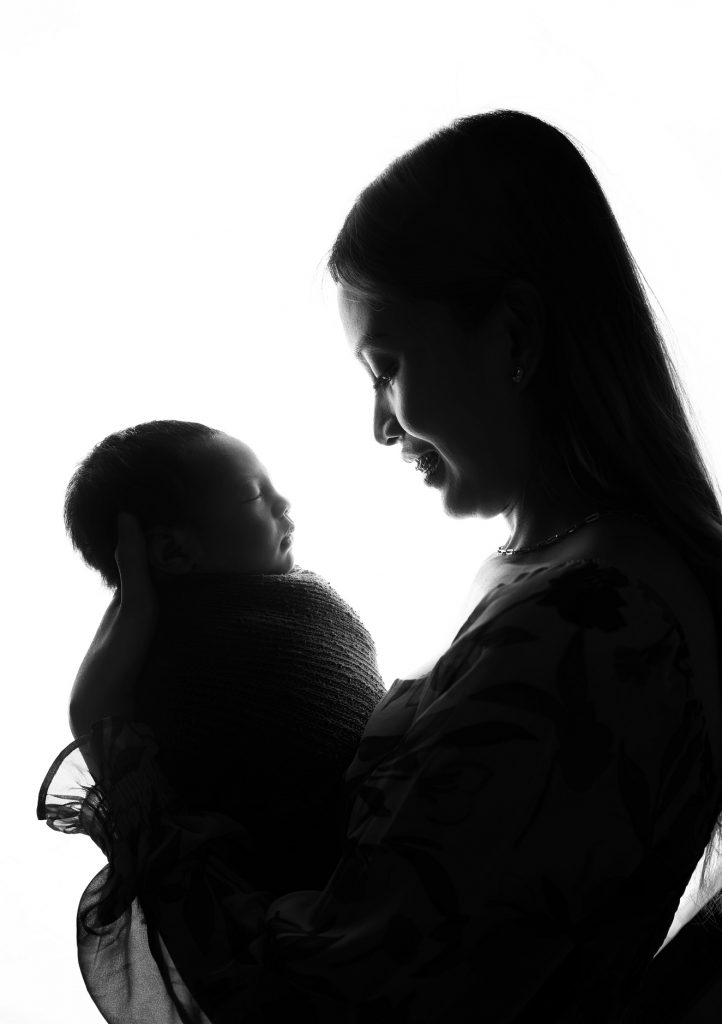 baby fort with his mother Christine Yalong in a black-and-white newborn session
