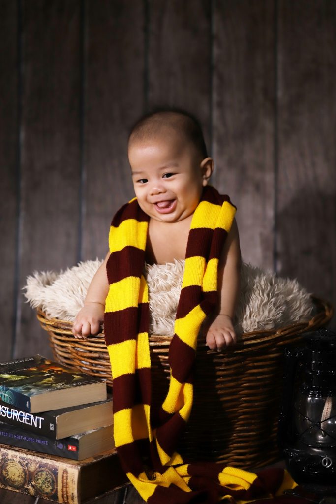 Baby Viktor haaving fun with this Harry Pothe-themed newborn session
