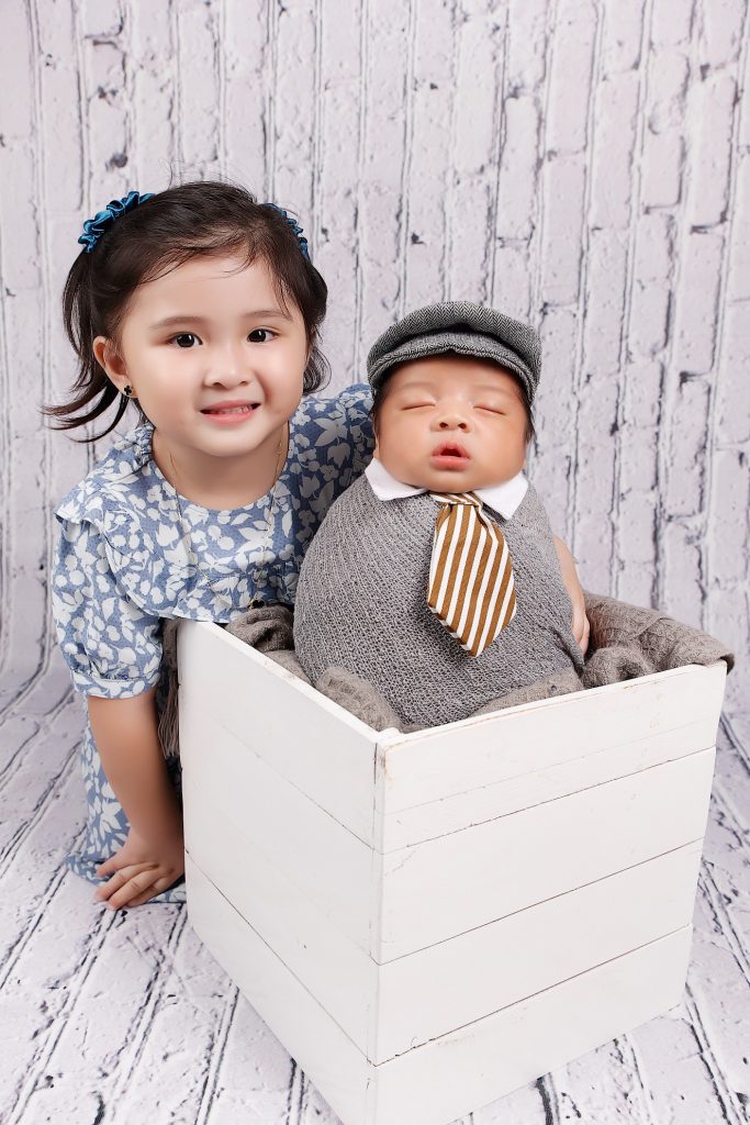 Baby yohan and his big sister posing for his newborn session